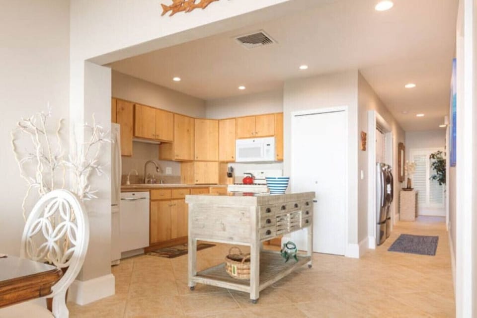Gourmet kitchen area offering wood cabinets and central island.