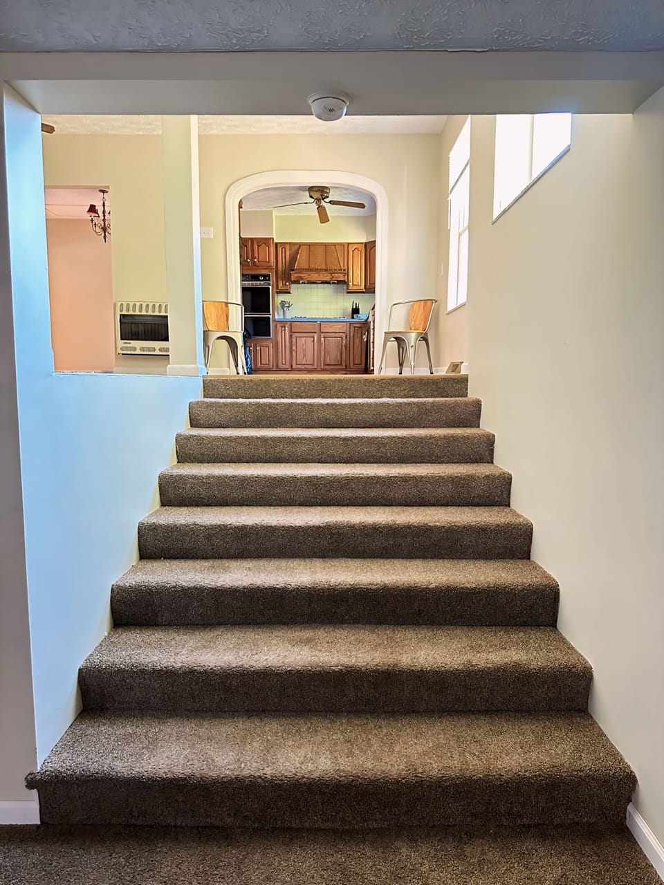 Large, oversized stairway from entertainment living room to dining & kitchen 