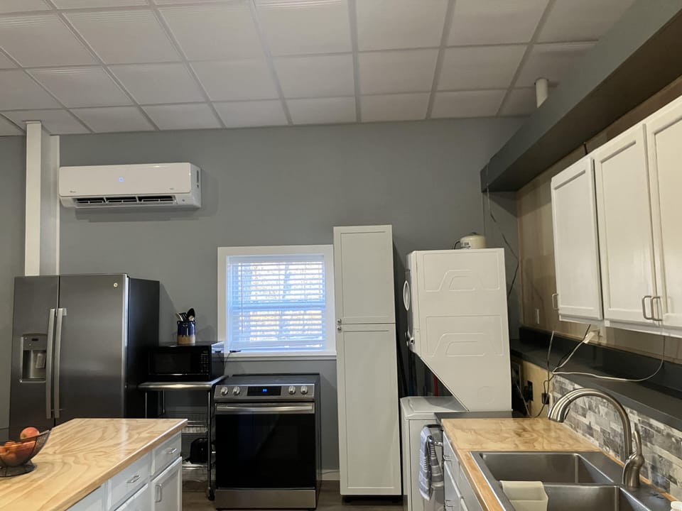 Stainless appliances, full frig, microwave, stackable washer/dryer.