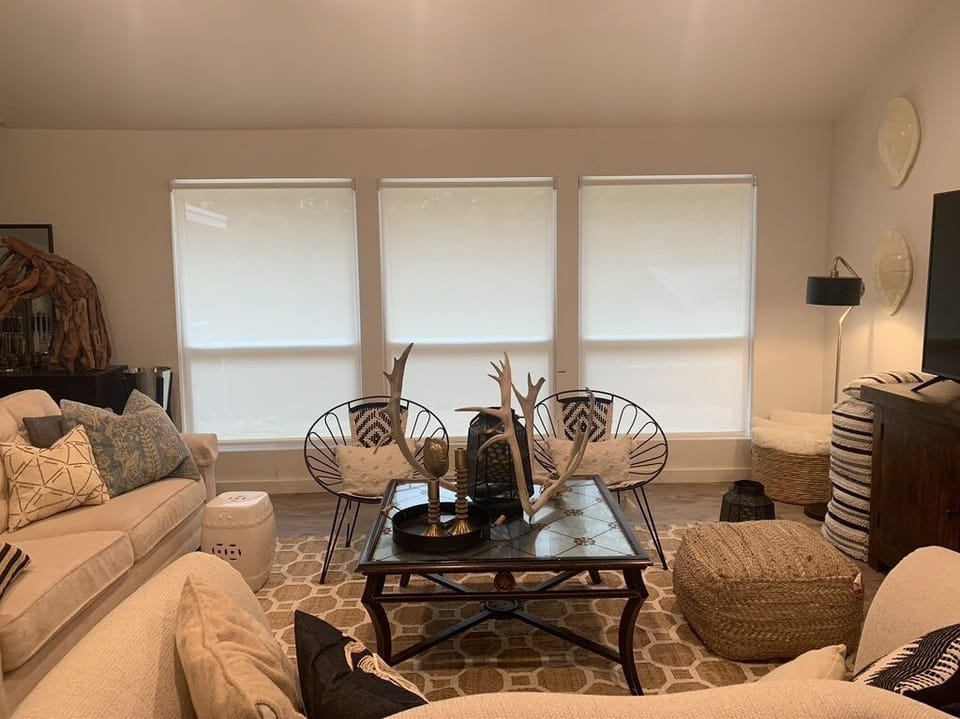 Living room has privacy shades and open to kitchen and dining