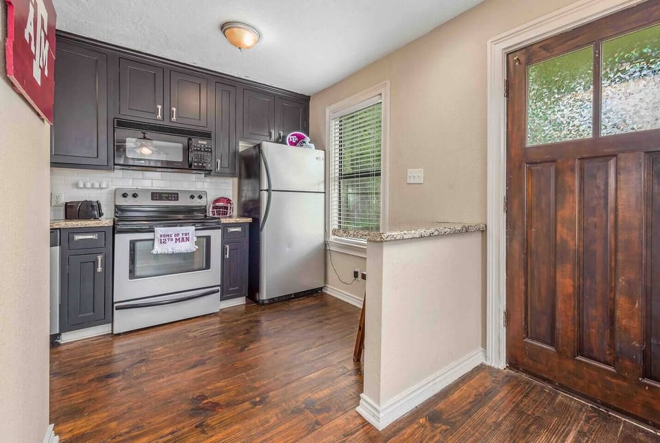 Pictured is the front door and the kitchen area. Freshly painted cabinets!Stained glass decal to provide privacy on the front door.