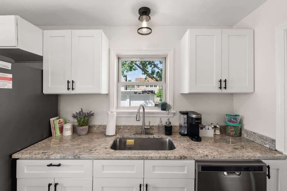 Step into this modern kitchen oasis with sleek white cabinets and glistening stainless steel appliances that effortlessly blend style and functionality.✨