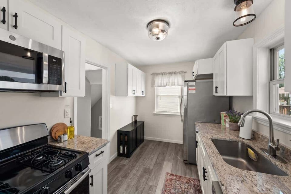 Enjoy the perfect marriage of sophistication and practicality in this stunning kitchen featuring pristine white cabinets and state-of-the-art stainless steel appliances. Time to cook up something amazing!