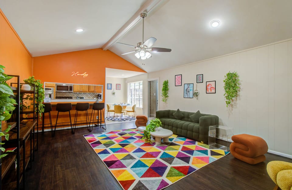 Spacious main living room with eclectic furniture and ceiling fan