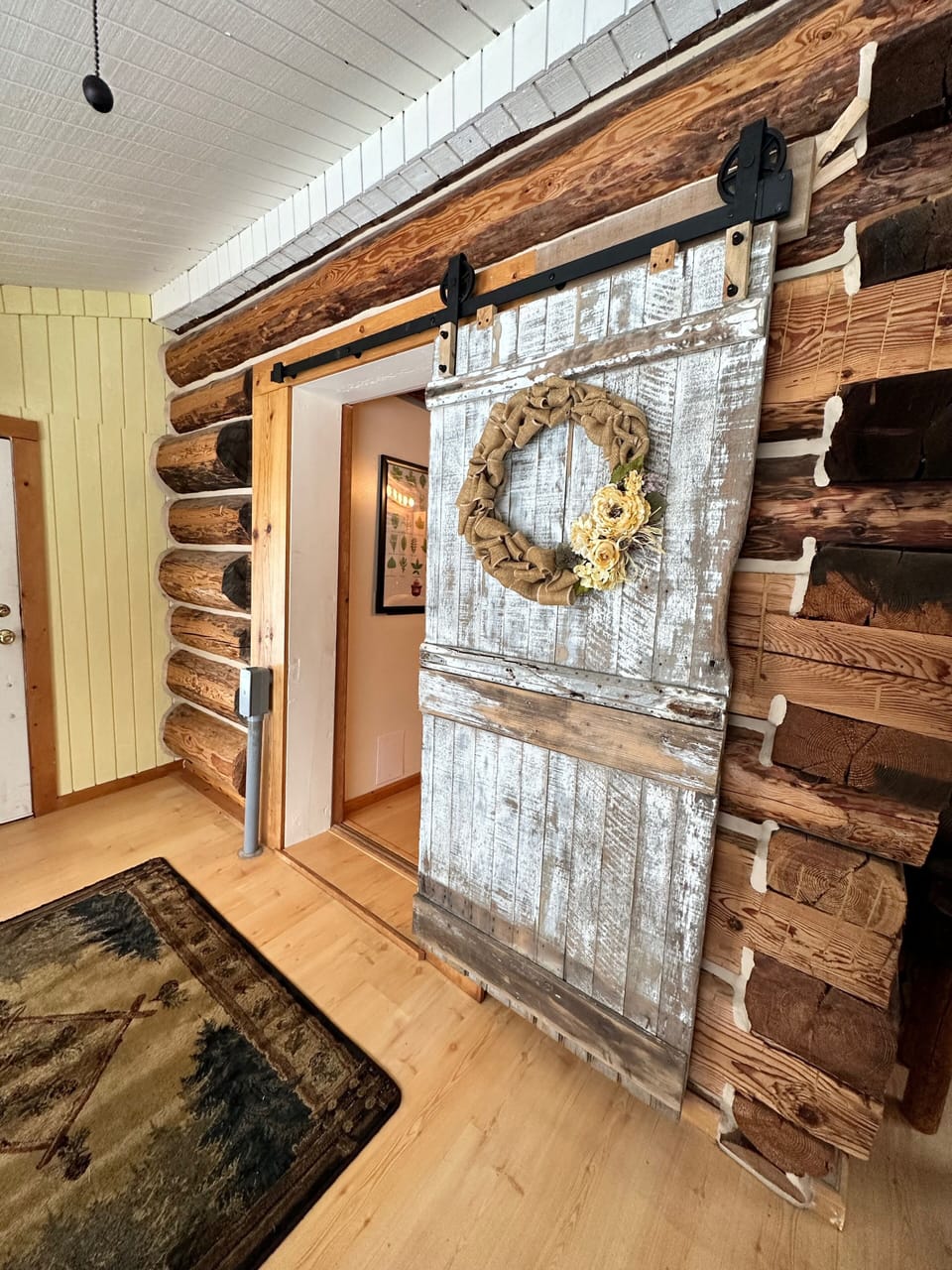 Old barn door welcomes you into the sunroom