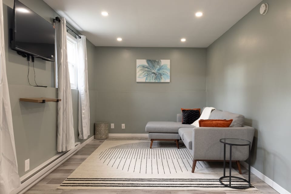 Spacious Living room with couch and Smart TV.