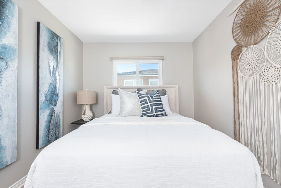 The guest bedroom features a queen bed and closet.
                