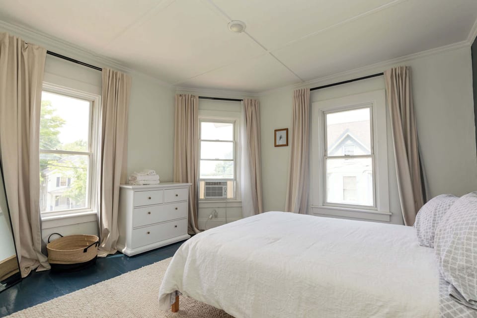 The master bedroom has lots of light for morning coffee in bed, and thick light blocking curtains for when you need just a little bit longer in bed in the morning