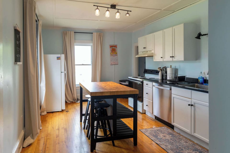 The kitchen has a butcher block island as a centerpiece, great for spreading out when cooking a meal or getting close for an intimate dinner