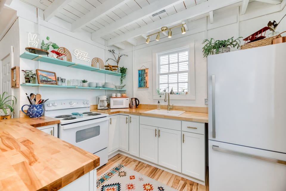 Kitchen - The glazed butcher block breakfast bar, upgraded appliances, and open shelves make High Vibe great place to catch a bite.