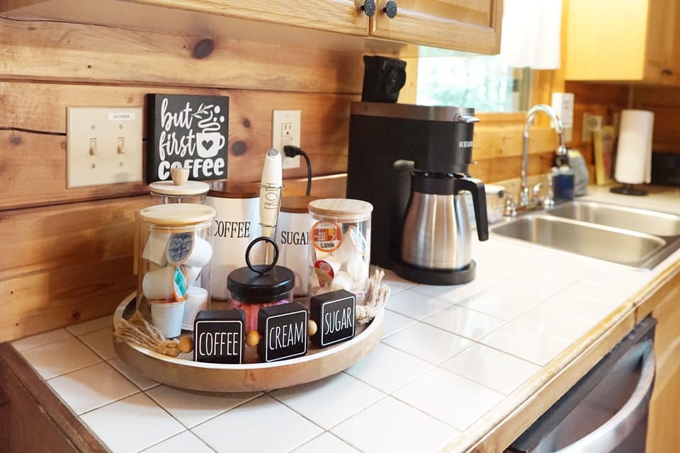 Wake up to a cozy coffee station fully stocked with all your morning essentials.