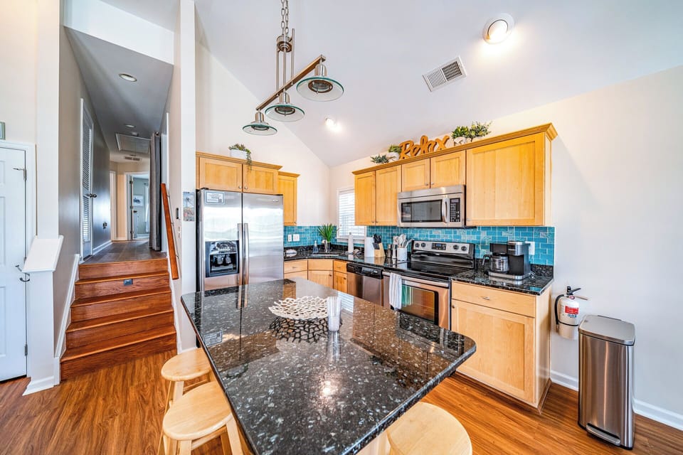 Spacious kitchen with granite island, and seating for three