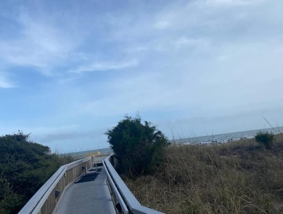 Steps to the beach with a sand-rinsing area