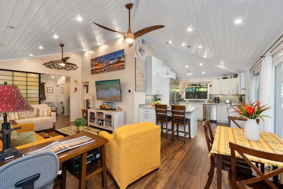 Gather in a spacious, light-filled living area that flows seamlessly into the dining space and modern kitchen