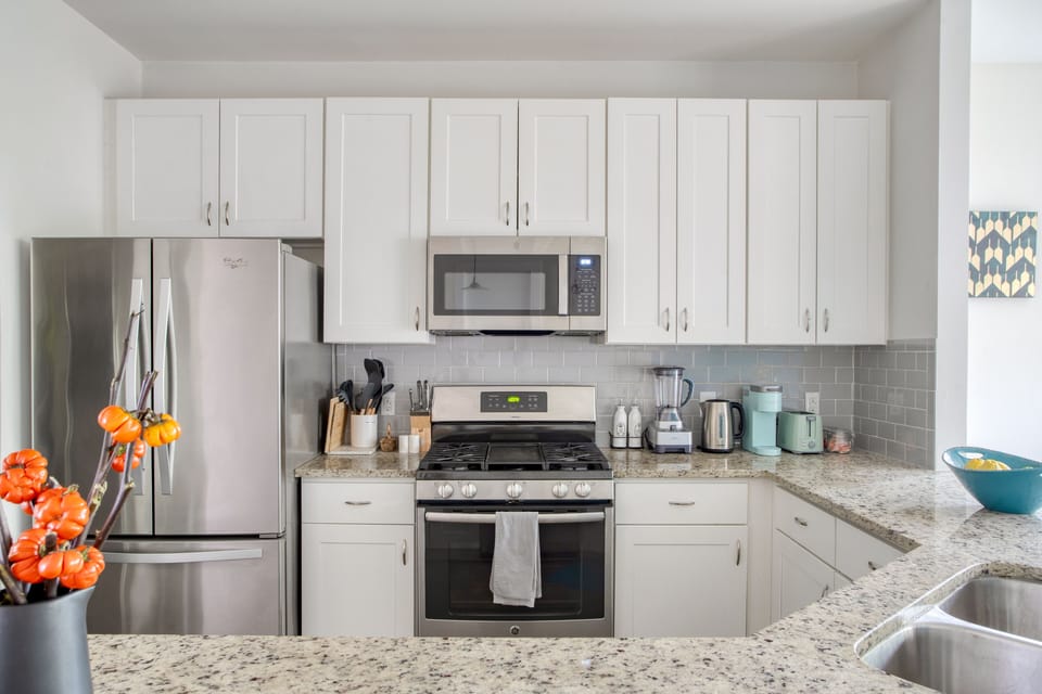 Fully equipped kitchen with sleek appliances and plenty of prep and storage space.