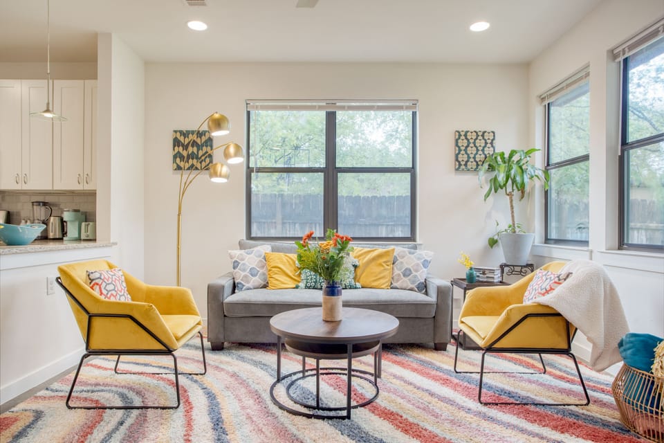 Sunny living room with a futon and television.