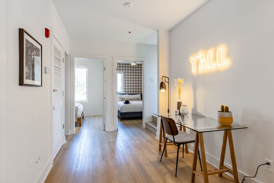 Desk/vanity space in the hallway can be used by remote workers or students.