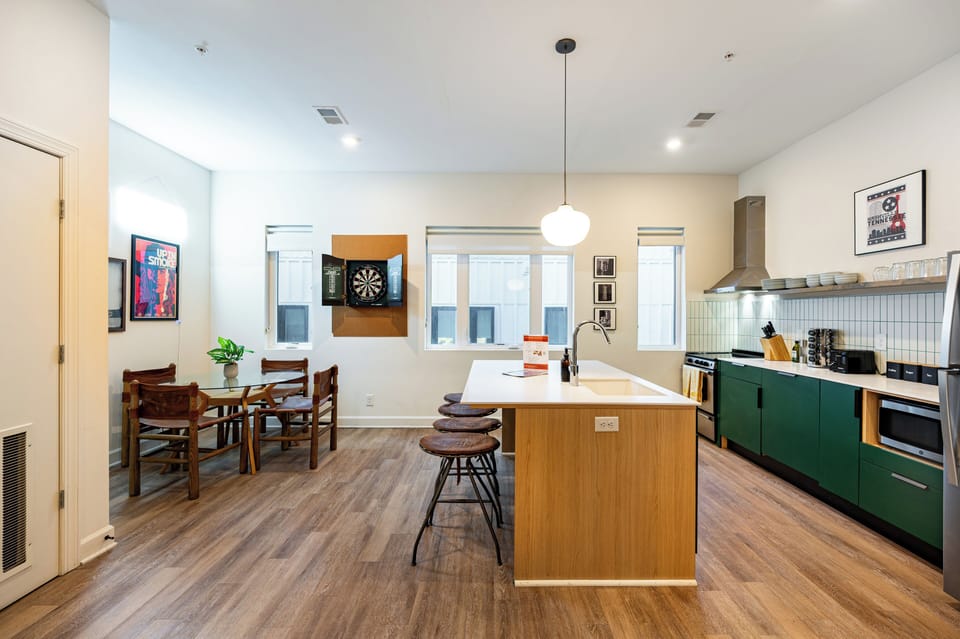 Sleek kitchen features an island with barstool seating.
