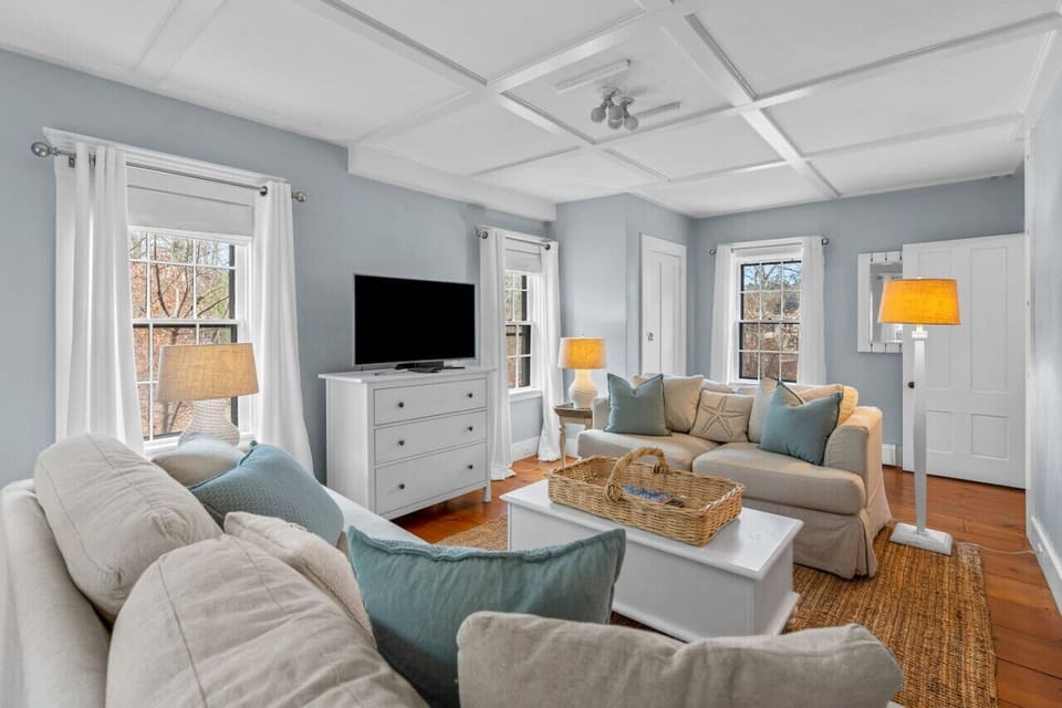 Cozy living room with plenty of seating, a Smart TV, and room-darkening shades.