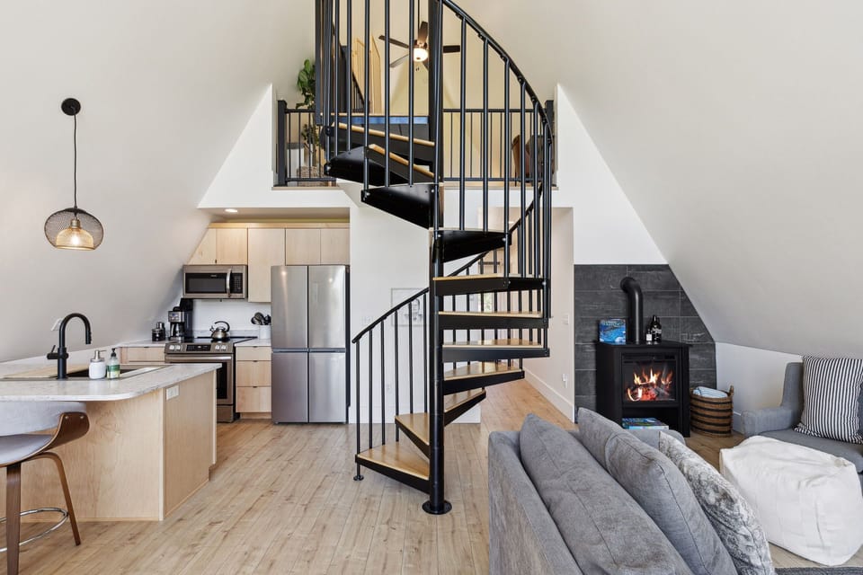 spiral staircase leading to king bed loft