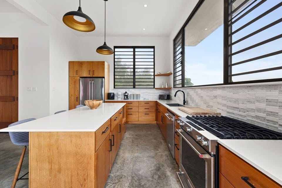 The well-equipped kitchen is a chef's delight, stocked with all the essential kitchen gadgets, gas stove, dishwasher and featuring a gas grill on the patio with an additional sink.