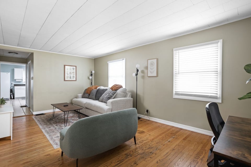 Relax on stylish seating with warm accents and a vibrant area rug—perfect for gathering!