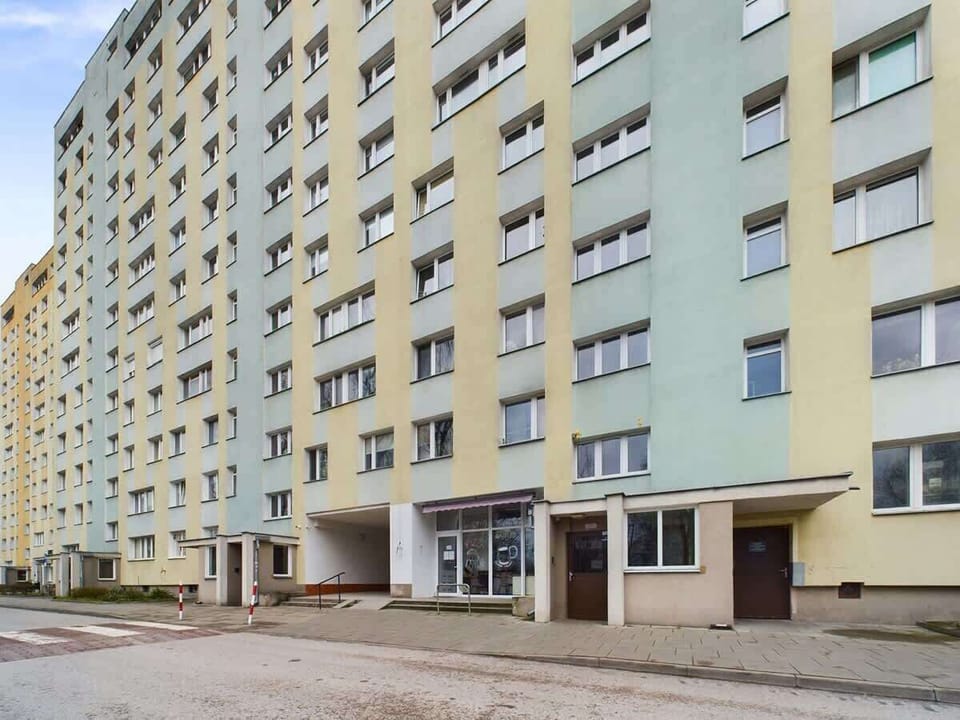 An exterior shot of a multi-story apartment building. 