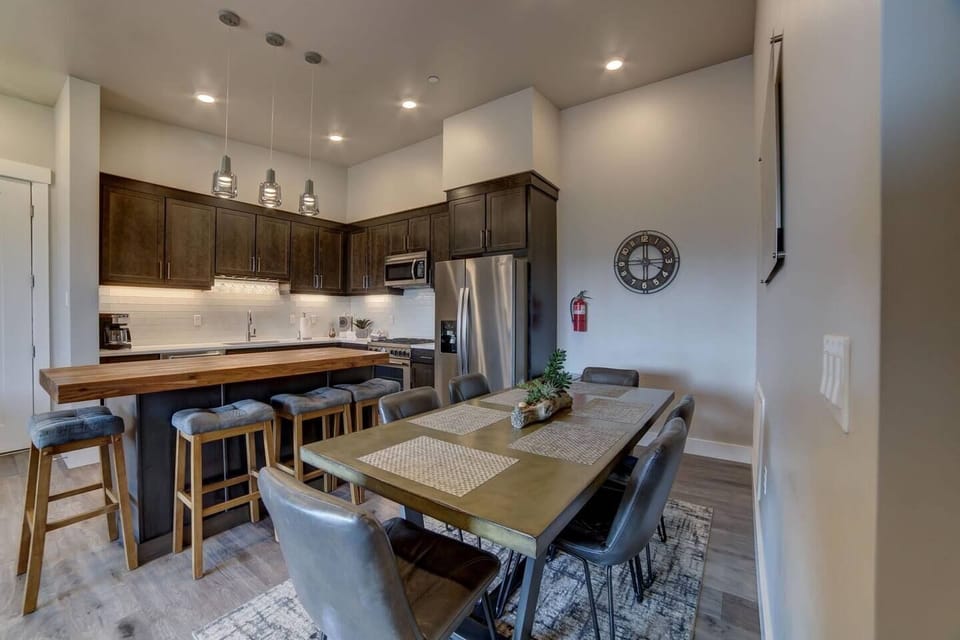 Open concept full kitchen with bar and dining table seat 10