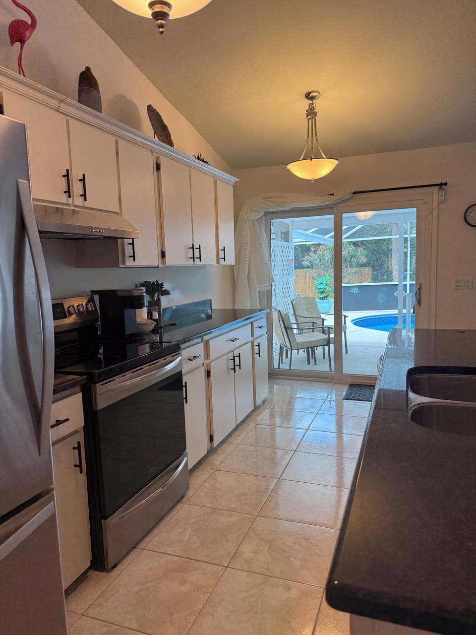 Kitchen with large granite island, deep sinks, garbage disposal and dishwasher. 