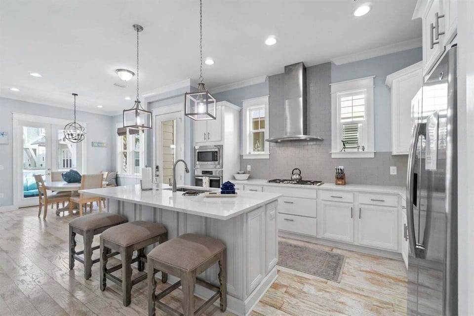 A sleek and stylish kitchen with high-end appliances, a spacious island, and elegant lighting.