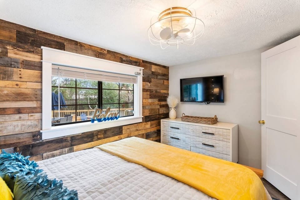 The third bedroom is absolutely adorable. Tucked away in the back of the house, it's so cozy and welcoming. The design details make a special space. It features a queen bed, a small closet and a television that's perfect for streaming. 