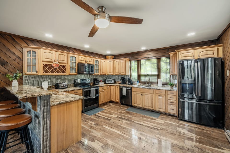 A classic kitchen with warm wood cabinets and stainless steel appliances.