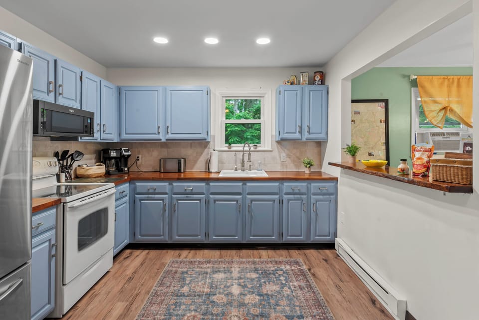 Sleek and Functional: Our kitchen boasts matching cupboards and all the essentials.