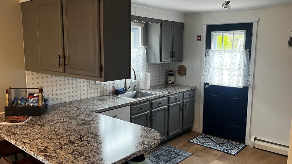Fully equipped kitchen with microwave, oven/stove, and full sized refrigerator. 