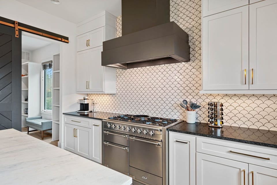Large, gas stove & hood.