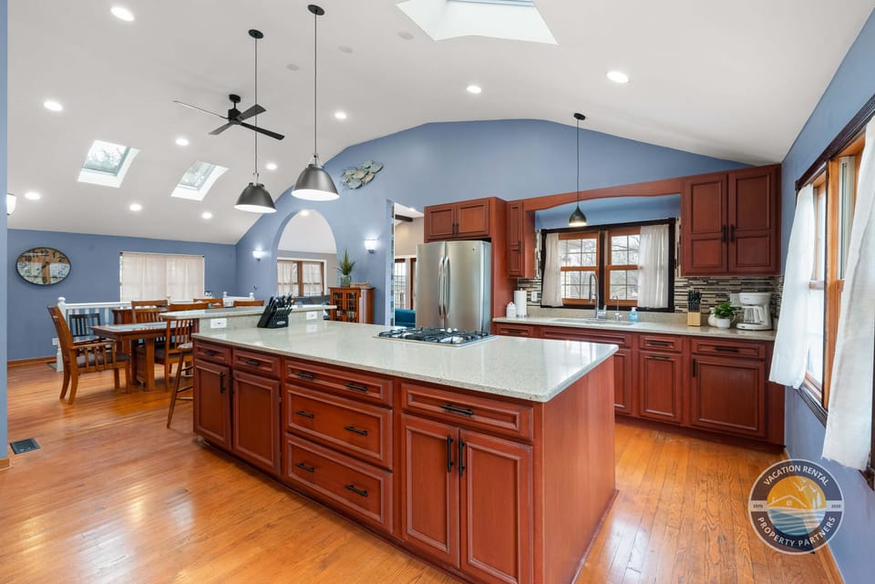 This fully equipped kitchen features a large island, modern appliances, and plenty of counter space for preparing meals, snacks, and shared moments.