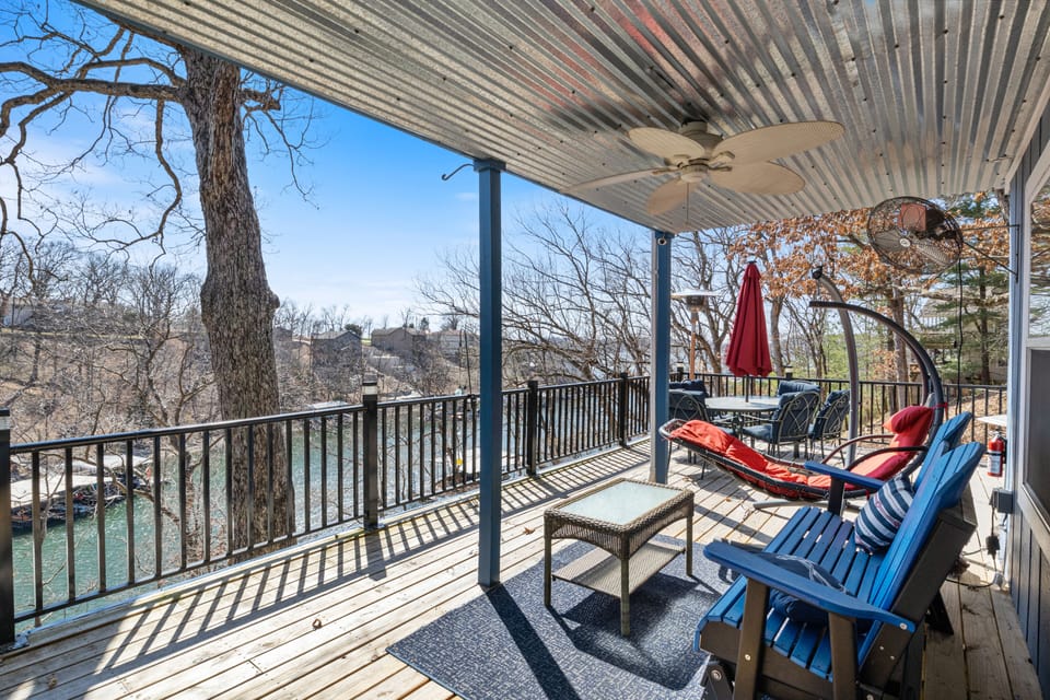Spacious deck with seating and scenic lake views, perfect for outdoor relaxation and dining.