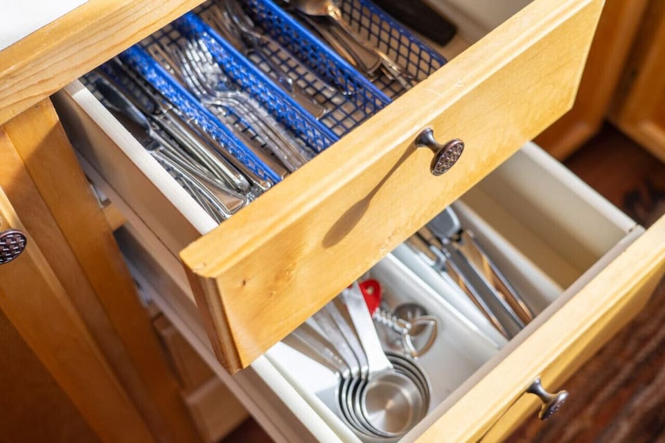 Fully stocked kitchen drawer with utensils and cooking essentials.