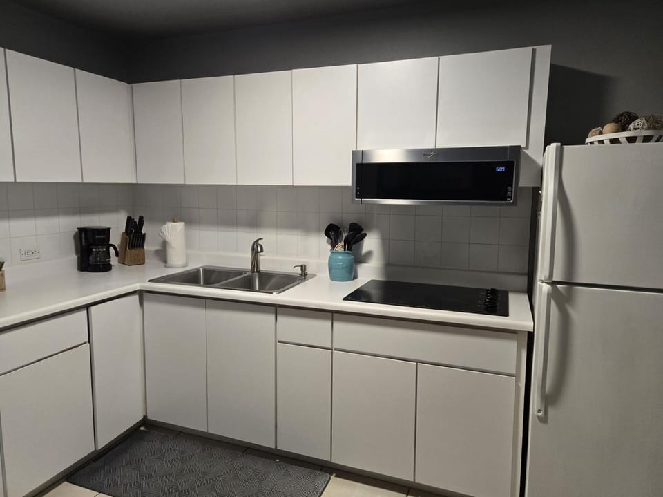 Kitchen with new Whirlpool low profile microwave. Full kitchen minus an oven.
