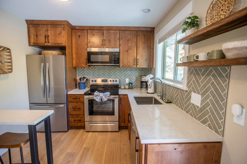 Kitchen with fridge, dishwasher, drip coffee maker, and breakfast bar.jpg