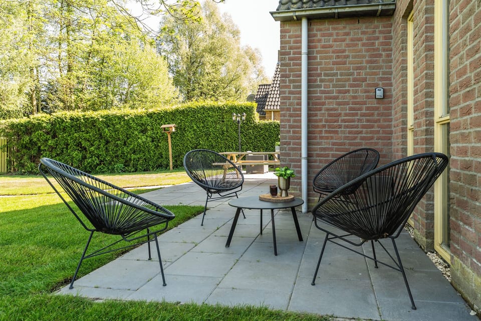 Sleek chairs, fresh air, and a view of green—this minimalist patio is made for quiet coffee moments and conversations that last. 