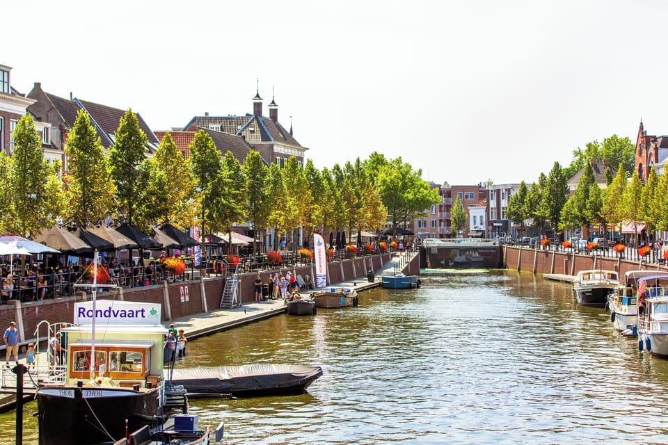Breda, a picturesque city in Brabant, offers canal views, charming cafés, and vibrant riverside life.