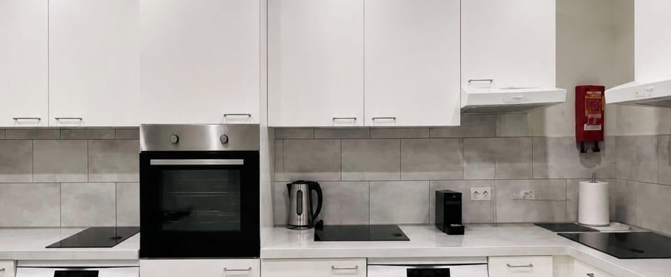 Large Shared Kitchen Fully Equipped with 2 Dishwashers, 3 Stoves, and 1 Oven