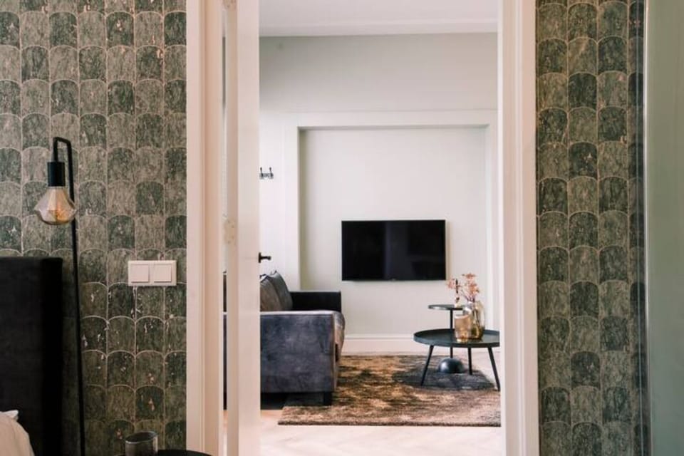 A glimpse into the cozy living area, complete with a stylish sofa and TV.