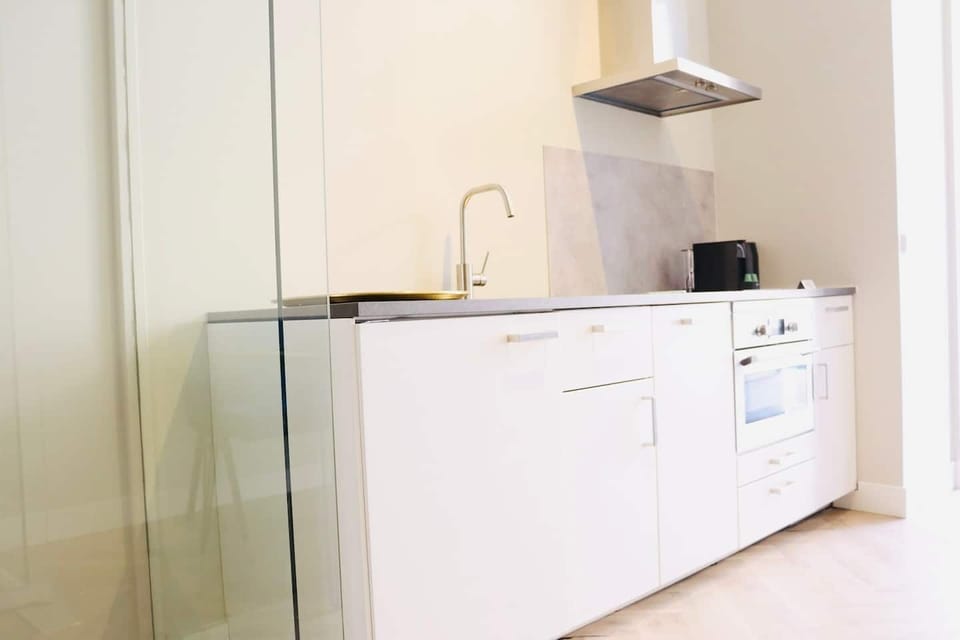 A sleek and modern kitchen setup, featuring clean lines and essential appliances for a functional space.