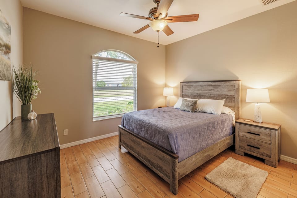 Tranquil Bedroom - - Unwind in this enchanting bedroom with a comfortable bed and warm lighting
- Natural light floods the space through a large window, creating a bright, airy feel
- Simple and calming design makes this room a perfect place to relax