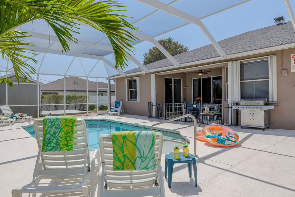 Relaxation Hub - - Enjoy the tranquil pool area with comfortable lounge chairs and vibrant towels
- Pool floats and colorful accessories enhance the relaxing atmosphere
- An ideal space for lounging, swimming, and soaking up the sun in privacy