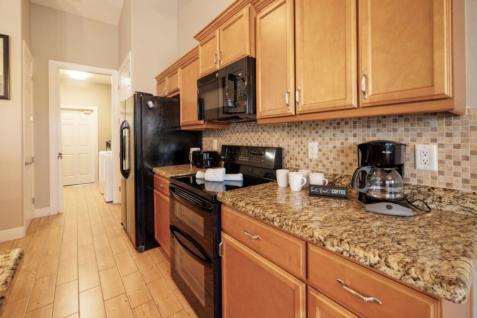 Gourmet Space - - Experience the charm of a fully equipped kitchen, complete with a cozy breakfast nook
- Elegant tile backsplash and wooden cabinetry add a touch of sophistication
- Space designed for convenience and culinary inspiration for your convenience