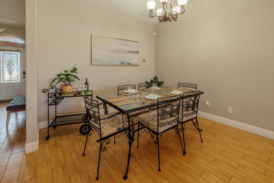 Family Feast - - Dine in sophistication with this stylish glass top table and intricate iron chairs
- Whether it’s a romantic dinner or a family feast, this space sets the perfect tone
- Serene wall art and soft lighting make every meal a delightful experience