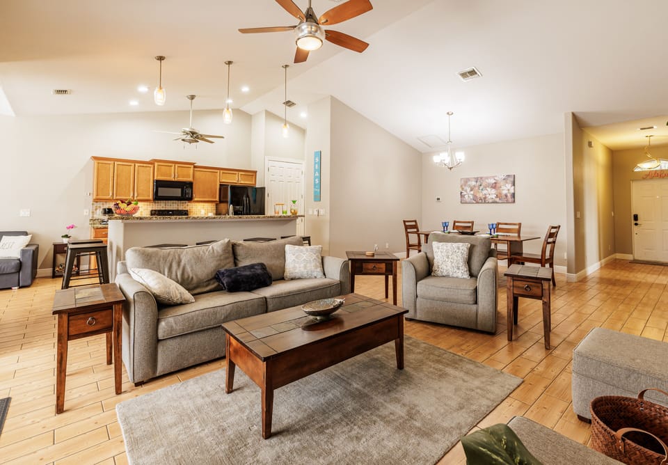 Spacious Retreat - - Relax in this bright, spacious living area with warm wood tones and cozy seating
- Open concept layout creates a welcoming space for gatherings and family time
- Perfect for movie nights, game days, or unwinding with a good book